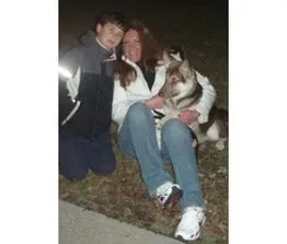 Elizabeth R. with her family dog after rehabilitation-focused training