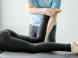 Kinesiologist guiding a client through an individualized movement exercise