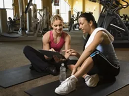Personal trainer and client discussing an individual exercise plan